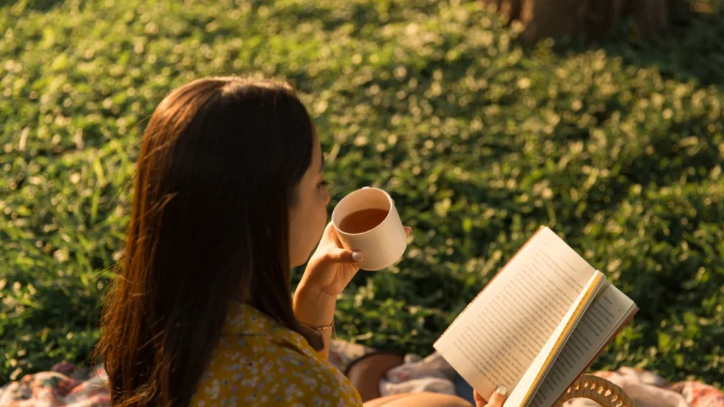 Girl drinking moringa tea while reading